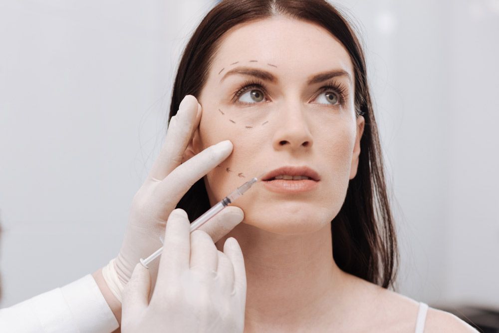 Female patient undergoing a consultation exam to establish her dermal filler treatment plan.