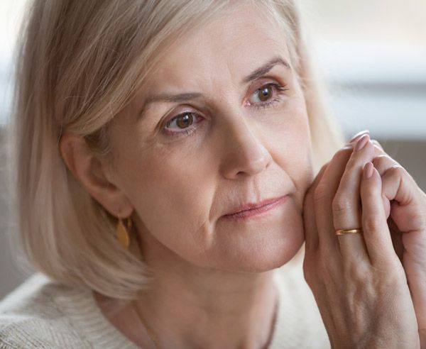 A woman looking sad and thinking