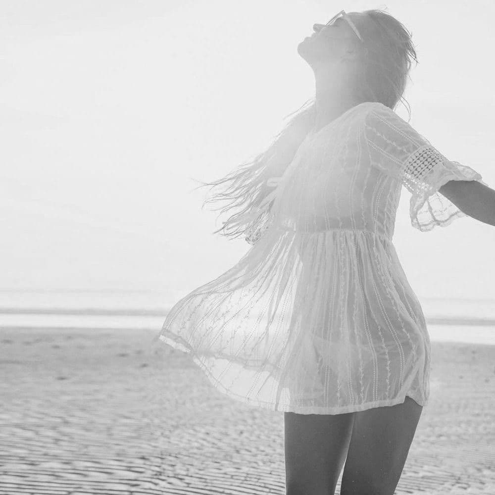 Woman leaning back with face tilted towards the sun