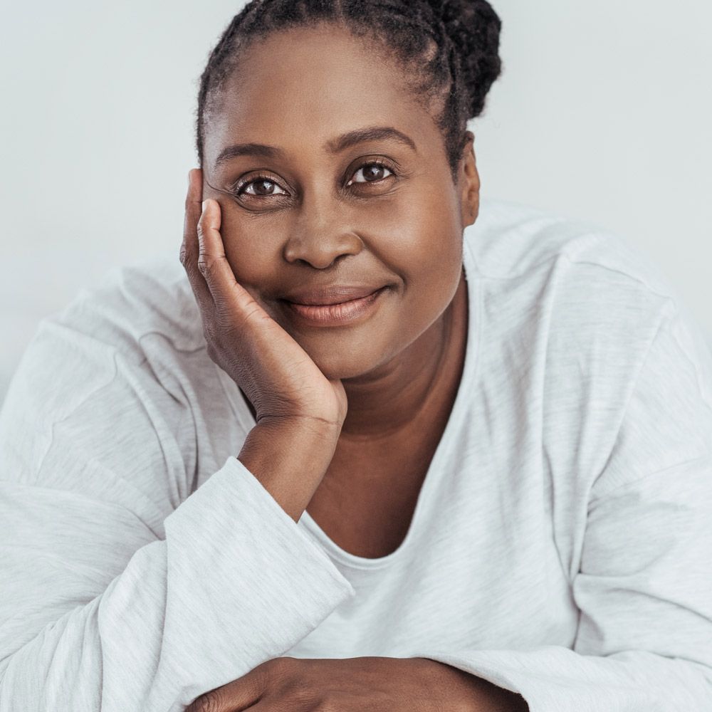 Woman holding hand to face